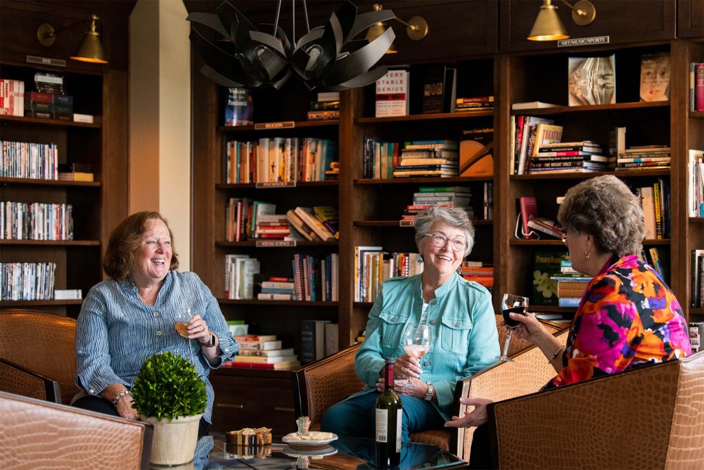 Friends talking together in The Vistas library.